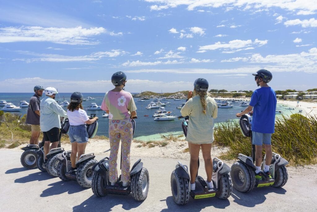 Guests on Segways overlooking the coast on the Coastal Explorer tour at Rottnest Island